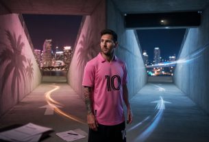 Messi stands in a Miami stadium tunnel, split between warm pink light and cool