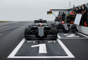 Top-down aerial/boom shot of the starting grid focusing on the pole position box and