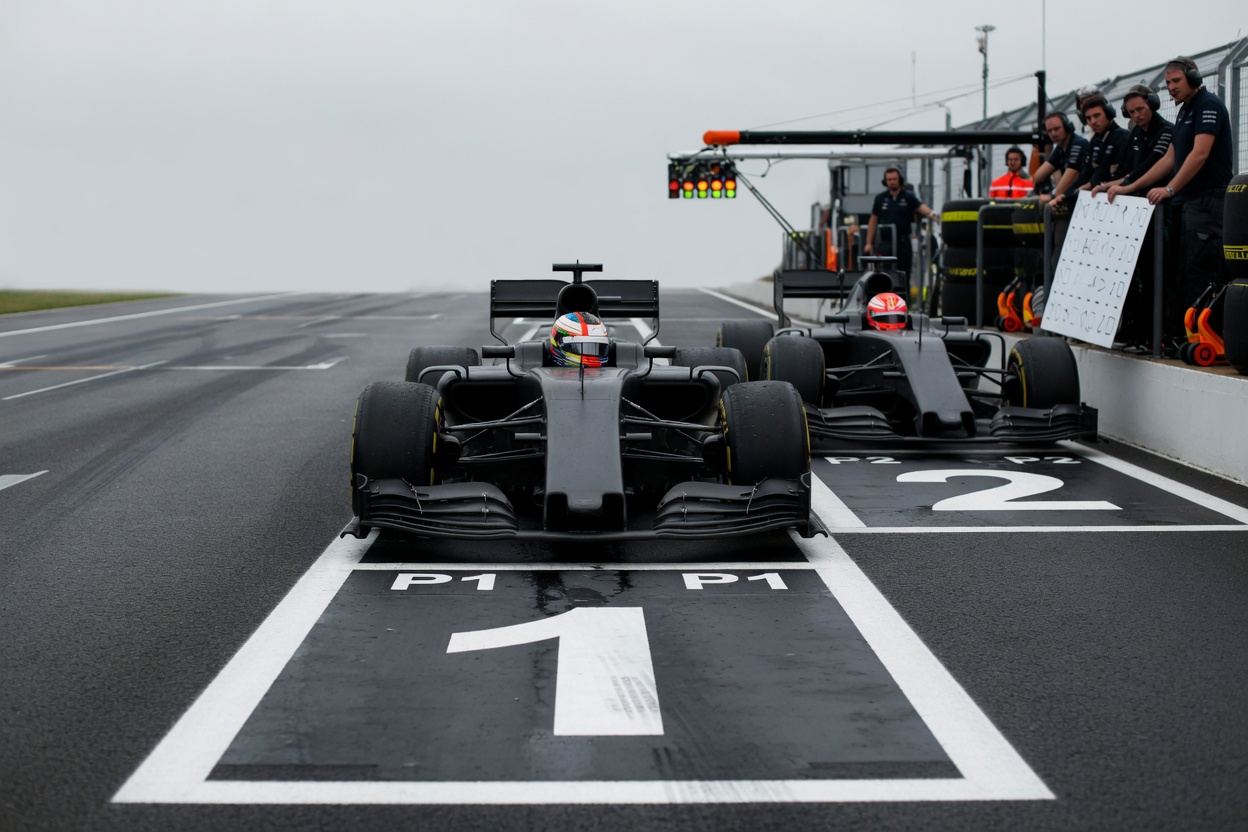 Top-down aerial/boom shot of the starting grid focusing on the pole position box and