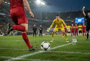 Low-angle photo of a Bundesliga penalty: ball on the spot, striker’s boot about to